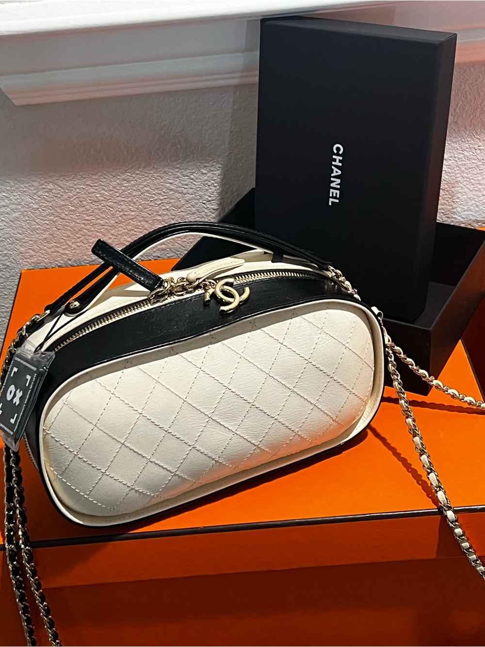 CHANEL Black & White Quilted Oval Crossbody Bag with Gold Hardware